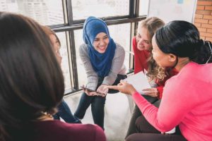 women talking in a group in women's rehab center