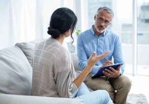 man and woman discussing cognitive behavioral therapy