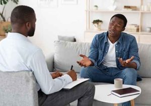 man speaking with therapist in dialectical behavioral therapy