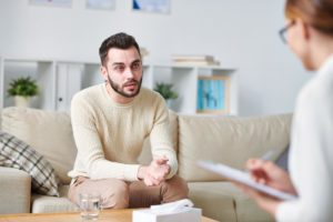 Man trying to choose an outpatient treatment center