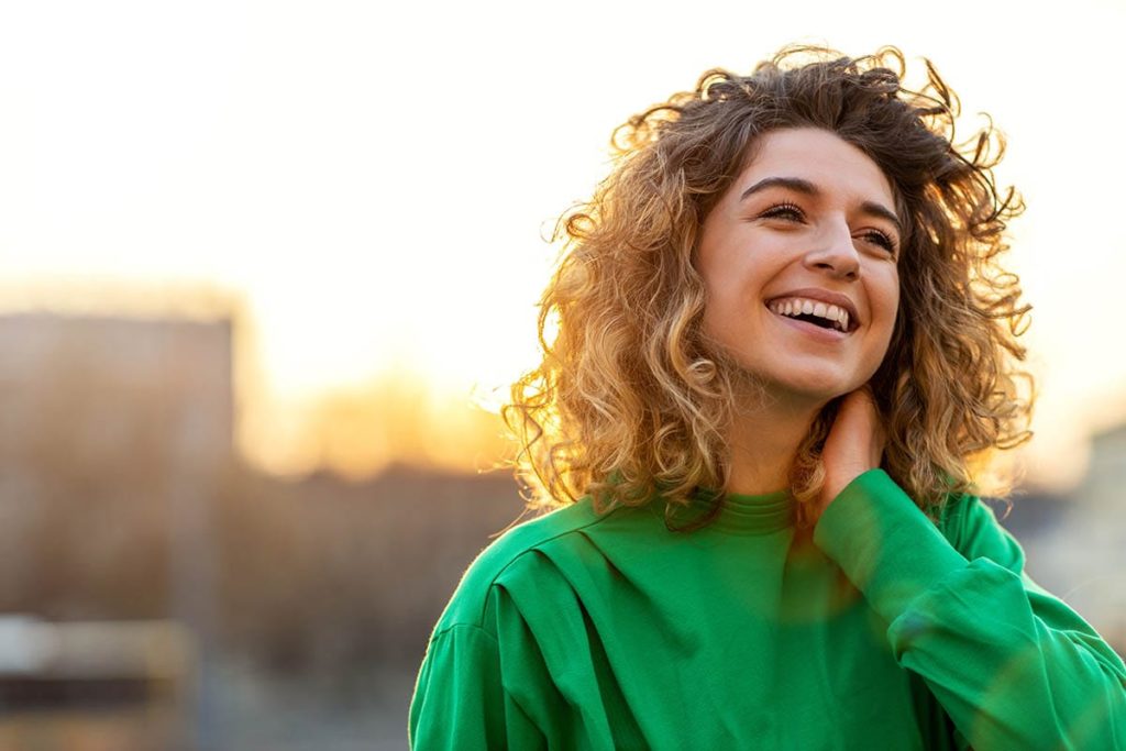 woman smiling because she living life after addiction