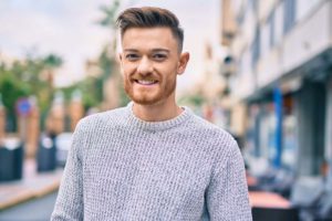 man smiling and learning reasons to get sober