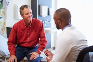 man talking with doctor about medications in MAT program