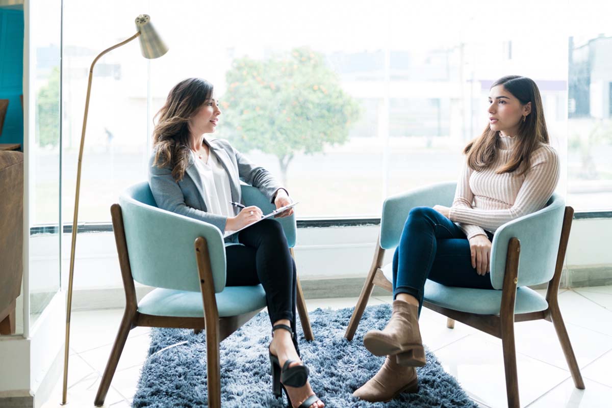 two woman discussing outpatient rehab centers